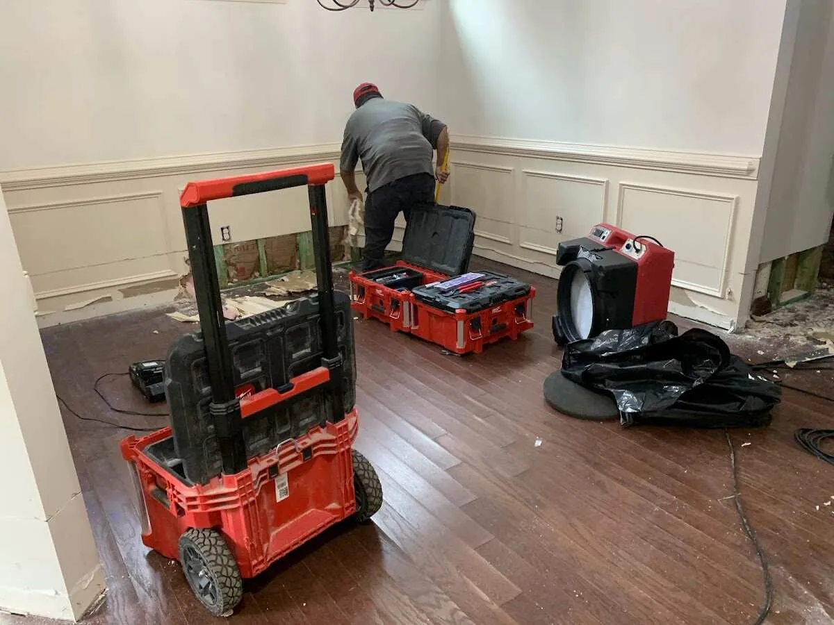 Technician setting up drying equipment for water damage in Dickinson